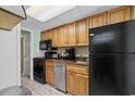 Compact kitchen with dark appliances and wood cabinets at 1105 S Ocean Blvd. # 228, Myrtle Beach, SC 29577