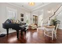 Spacious living room with hardwood floors, piano, and ample natural light at 268 Calais Ave., Georgetown, SC 29440