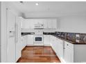 White kitchen with granite countertops and hardwood floors at 801 Crumpet Ct. # 1137, Myrtle Beach, SC 29579