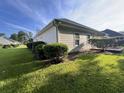 View of the house's side exterior, showcasing a deck and landscaping at 709 Ashley Manor Dr., Longs, SC 29568