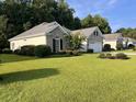 House exterior showcasing a ranch style home with a well maintained lawn at 709 Ashley Manor Dr., Longs, SC 29568