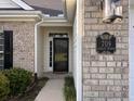 Brick house exterior with a landscaped yard and a two-car garage at 709 Ashley Manor Dr., Longs, SC 29568