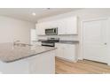 White shaker cabinets, granite countertops and stainless steel appliances at 170 Calm Dr., Little River, SC 29566