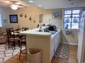 Galley kitchen with white cabinets and a breakfast bar at 351 Lake Arrowhead Rd. # 20-179, Myrtle Beach, SC 29572
