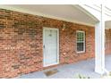 Building entrance with brick facade and storm door at 3927 Gladiola Ct. # 103, Myrtle Beach, SC 29588