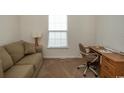 Bright home office features a comfortable couch, desk, and window at 4917 Twin Pond Ct. # 102, Myrtle Beach, SC 29579