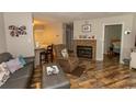 Living room with hardwood floors, fireplace, and comfortable seating at 1206 Benna Dr. # 4-F, Myrtle Beach, SC 29577