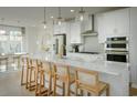 Island kitchen with white cabinets, quartz countertops, and gold accents at Tbd Jazz Ct. # Tbd, Myrtle Beach, SC 29572