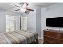 Bedroom with double bed, dresser, TV, and bathroom access at 1321 S Ocean Blvd. # 606, North Myrtle Beach, SC 29582
