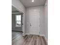 Bright and airy entryway with hardwood floors and white door at 1617 Littleleaf Loop, North Myrtle Beach, SC 29582