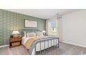 Bedroom with a metal bed frame, green anchor wallpaper, and wood nightstands at 327 Acosta Circle, Conway, SC 29527