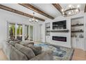 Open living space featuring exposed wooden beams and a modern fireplace at 2056 Summer Rose Ln., Myrtle Beach, SC 29579