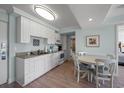 Efficient galley kitchen with white cabinets and granite countertops at 14290 Ocean Hwy. # 208, Pawleys Island, SC 29585