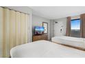 Bedroom with two beds, TV, and ocean view at 1501 S Ocean Blvd. # 1135, Myrtle Beach, SC 29577