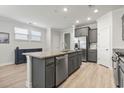 Modern kitchen with gray cabinets, granite countertops, and stainless steel appliances at 284 Goldenrod Circle, Little River, SC 29566