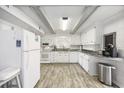 White kitchen with granite countertops and stainless steel appliances at 605 36Th Ave. S, North Myrtle Beach, SC 29582