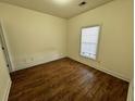 Bright bedroom with wood-look floors and large window at 5034 Belleglen Ct. # 101, Myrtle Beach, SC 29579