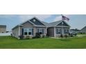 Gray house with stone accents and a landscaped lawn at 6103 Cates Bay Hwy., Conway, SC 29527