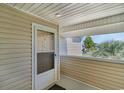 Screened porch with exterior door and view of the neighborhood at 8862 Cloister Dr. # F, Myrtle Beach, SC 29575