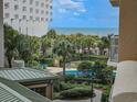 Resort-style pool with ocean view, palm trees at 9994 Beach Club Dr. # 205, Myrtle Beach, SC 29572