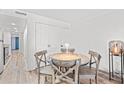 Charming dining area with rustic wooden table and four chairs at 7509 N Ocean Blvd. # 103, Myrtle Beach, SC 29572