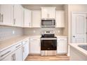 Bright, spacious kitchen featuring white shaker cabinets, stainless steel appliances, and sleek countertops at 4723 Huckleberry Ln., Conway, SC 29526