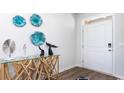 Bright entryway with glass console table and unique wall decor at 193 Hadley Springs Ave, Longs, SC 29568