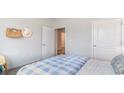 Guest bedroom with a blue and white checkered comforter and an adjacent bathroom at 201 Hadley Springs Ave, Longs, SC 29568