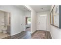 Bright and airy entryway with hardwood floors, a view into a bedroom and bathroom, and framed art at 201 Hadley Springs Ave, Longs, SC 29568