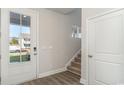 Bright entryway with stairs, wood-look floors, and coat closet at 1020 Barrington Way, Conway, SC 29526