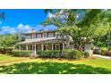 Two story home with covered porch, landscaping, and a brick facade at 7602 Glenwood Dr., Myrtle Beach, SC 29572