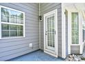 Back exterior door access with white door and sidelights, leading to a small patio at 1202 Tiffany Ln. # G, Myrtle Beach, SC 29577