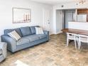 Bright living room with a sofa and dining area at 202 74Th Ave. N # 2447-2448, Myrtle Beach, SC 29572