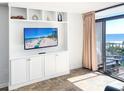 Living room with built-in entertainment center and ocean view at 202 74Th Ave. N # 2447-2448, Myrtle Beach, SC 29572
