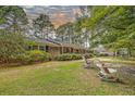 Brick ranch home with side yard and rocking chairs at 263 Arcadia Dr., Pawleys Island, SC 29585