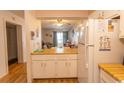 Kitchen features white cabinets, wood countertops, and appliances at 4305 S Ocean Blvd. # 106, North Myrtle Beach, SC 29582