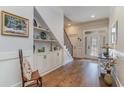 Elegant entryway with built-in shelving, hardwood floors, and a staircase at 565 Starlit Way, Myrtle Beach, SC 29579