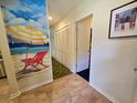 Hallway with beach-themed wall art and closet space at 226 Westleton Dr. # 19-D, Myrtle Beach, SC 29572