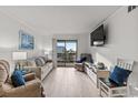 Bright living room featuring comfortable seating and a large TV at 6001 N Ocean Blvd. # 242, North Myrtle Beach, SC 29582