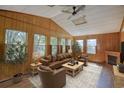 Relaxing sunroom with wood paneling, leather furniture, and fireplace at 1119 Blue Ridge Trail, North Myrtle Beach, SC 29582