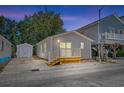 Evening view of cottage with deck and storage shed at 6001-1573 S Kings Hwy., Myrtle Beach, SC 29575