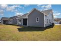 Gray-sided house with a covered patio, situated on a grassy lot at 1124 Cypress Shoal Dr., Conway, SC 29526