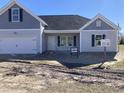 Front exterior of a home with gray siding, white trim, and attached two-car garage at 1060 Log Cabin Rd., Loris, SC 29569