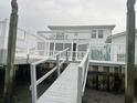White wooden deck and walkway leading to a waterfront home at 329 54Th Ave. N, North Myrtle Beach, SC 29582