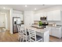 Modern kitchen with white cabinets, granite countertops, and stainless steel appliances at 115 Talladega Dr. # 405, Myrtle Beach, SC 29579