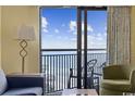 Living room with comfortable seating and a balcony overlooking the ocean at 7100 Ocean Blvd. N # 925, Myrtle Beach, SC 29572