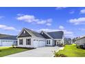 Two-car garage and light beige exterior with gray roof at 284 Starlit Way, Myrtle Beach, SC 29579