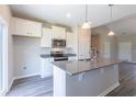 Modern kitchen with white cabinets, granite countertops, stainless steel appliances, and an island at 2323 King Farm Rd., Aynor, SC 29511