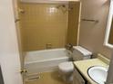 Clean bathroom with yellow tile, bathtub, toilet, and sink at 1025 Carolina Rd. # G-3, Conway, SC 29526