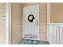 Condo entrance with a wreath and starfish welcome mat at 631 Woodmoor Dr. # 303, Murrells Inlet, SC 29576